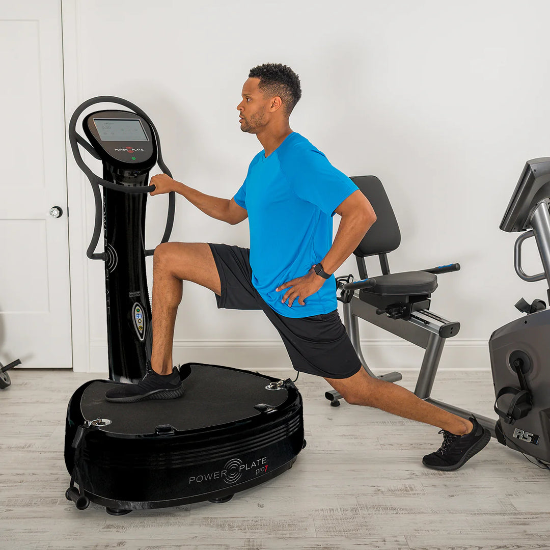 Man using a Black Power Plate pro7 in a home gym setting