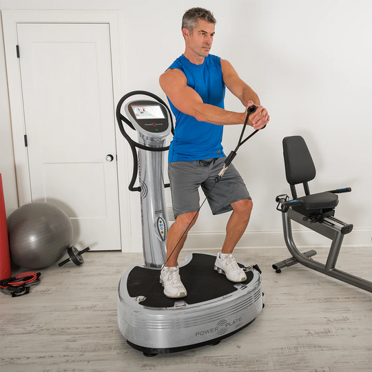 Man using a Silver Power Plate pro7 in a home gym setting